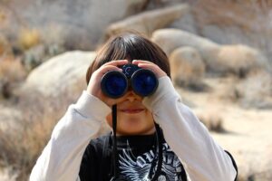 woman looking through binoculars