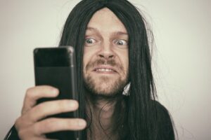 silly man looking at phone