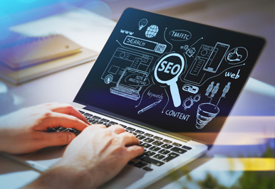 Laptop displaying SEO concepts and graphics
