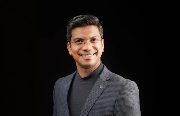Smiling man in formal attire.