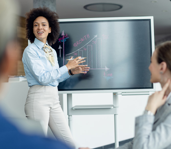 Woman presenting growth chart to audience