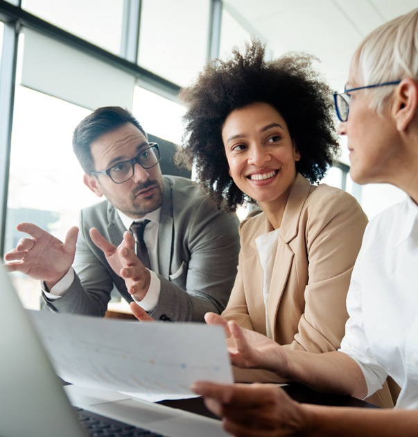 Three professionals discussing in office